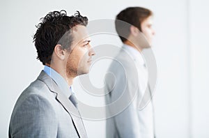 Comprehending success. Profile of two businessmen looking away thoughtfully.