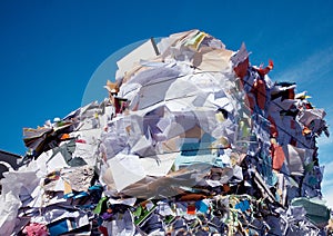 Compressed blocks of paper at recycling plant photo