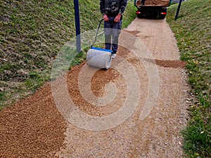 compressing the gravel of the new park threshing path. lawn seed is