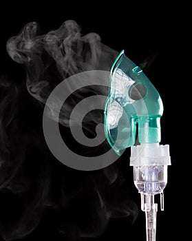 Compressor nebulizer at work, isolated on black