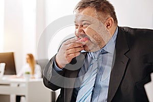 Compulsive immoderate guy engulfing junk food