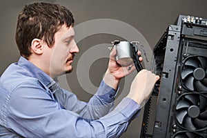 Computer assembling service. Serviceman installing liquid cooling system on processor