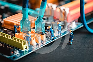 Computer assembly - technicians connecting sata cable on motherboard photo