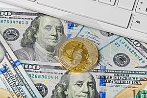 Computer and bitcoins on money - business background