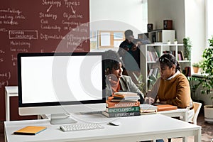 Computer with Blank White Screen on Table in Class