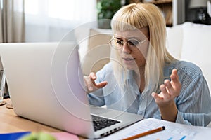 Computer bug. Young nervous frustrated freelance woman in home office having trouble with laptop or internet connection Anxious