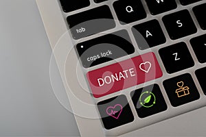 A computer button with the text DONATE. The concept of spread awareness and encourage donations for health, those in need, and