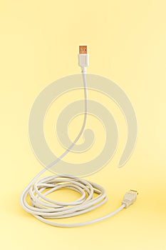 Computer cable for connection on a yellow background. The concept of technology and communication. Minimal composition