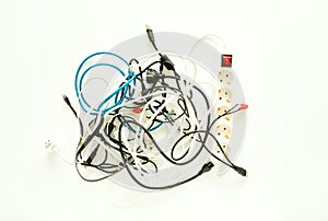 Computer cables, wires, chargers in a messy heap. Home electronic chaos concept, flat lay