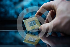 Computer chip in hands. A chipset is a set of electronic component that is integrated and flows data between the processor.