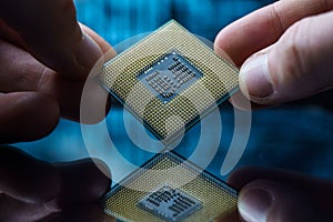 Computer chip in hands. A chipset is a set of electronic component that is integrated and flows data between the processor.