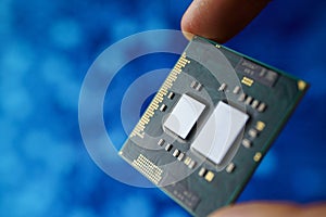 Computer chip in hands. A chipset is a set of electronic component that is integrated and flows data between the processor.