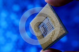 Computer chip in hands. A chipset is a set of electronic component that is integrated and flows data between the processor.