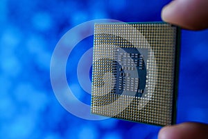 Computer chip in hands. A chipset is a set of electronic component that is integrated and flows data between the processor.