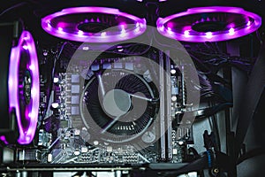 Computer circuit board and CPU cooling fans illuminated by internal LED