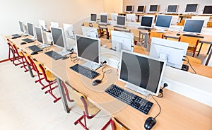 Computer class with rows of desktop computers in school