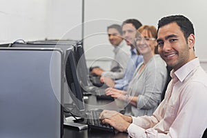 Computer class sitting in front of computers