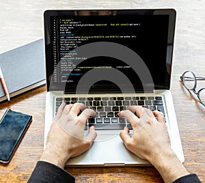 Man programming on a computer, office background