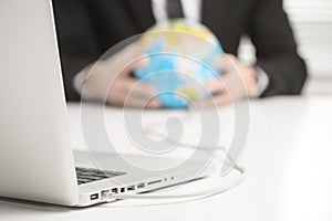 Computer connected to earth globe