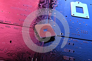 Computer cpu processor chip on circuit board ,motherboard background. Close-up. With red-blue lighting