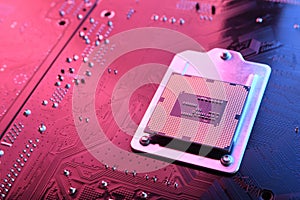 Computer cpu processor chip on circuit board ,motherboard background. Close-up. With red-blue lighting