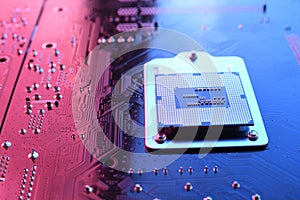 Computer cpu processor chip on circuit board ,motherboard background. Close-up. With red-blue lighting