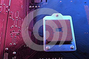 Computer cpu processor chip on circuit board ,motherboard background. Close-up. With red-blue lighting