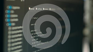 Computer display of software developer typing database functions script on terminal window