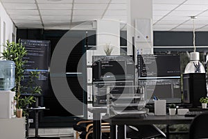 Computer displays on table running programming code html algorithms