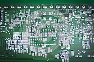 Computer electronic microcircuits, macro, green background. Electronic circuit board close up