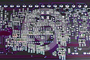 Computer electronic microcircuits, macro, purple background. Electronic circuit board close up