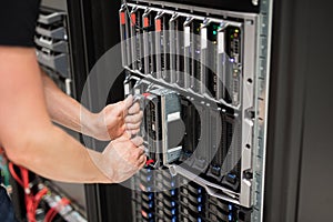 Computer Engineer Installing Blade Server In Data Center