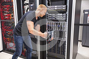 Computer Engineer Installing Blade Server In Datacenter