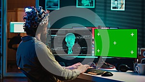 Computer engineer starting mind upload process using green screen PC