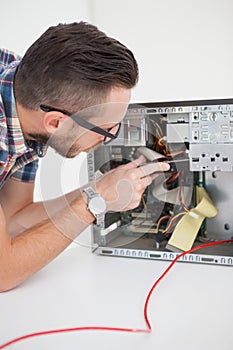 Computer engineer working on broken console with screwdriver