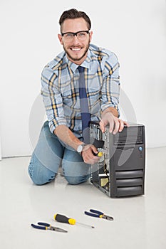 Computer engineer working on broken console with screwdriver