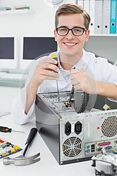 Computer engineer working on broken device with screwdriver