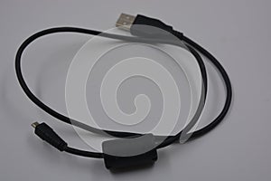 Computer equipment, a long, black micro USB cable from a digital camera to a regular computer.