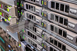 Computer equipment works in the server room of the data center. Array of database servers with many hard drives and service tag.