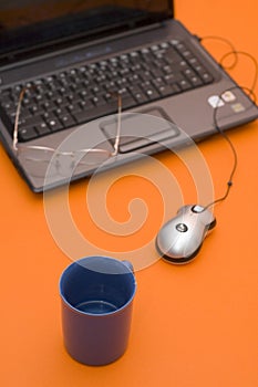 Computer with Eyeglasses and Cup