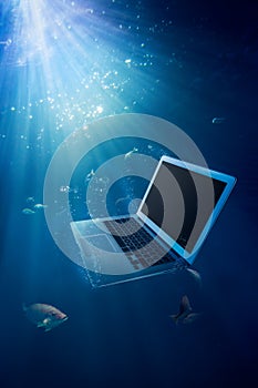 Computer failure concept with laptop on water