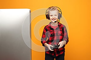 Computer game. Young boy playing computer games on headphones.