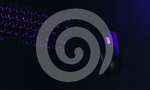 Computer gaming mouse and keyboard with purple backlight