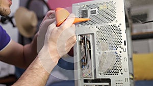 A Computer Geek Boy Cleaning Computer With Compressed Air