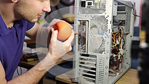 A Computer Geek Boy Cleaning Computer With Compressed Air