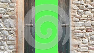 Computer generated animation of an old wooden door opening to green screen.