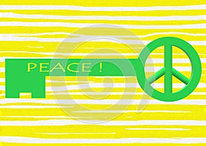 A bright green colored key with a peace symbol ring for key chain hooking against a light yellow striped backdrop