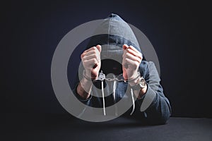 Computer hacker in handcuffs. Cyber crime