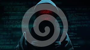 Computer hacker with hoodie. Computer abstract digital code at the background. Darknet fraud and cryptocurrency bitcoin