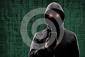 Computer hacker in mask and hoodie over abstract binary background. Obscured dark face. Data thief, internet fraud